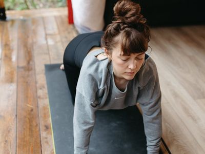 Close-up of comfortable sportswear and a yoga mat on the floor.
