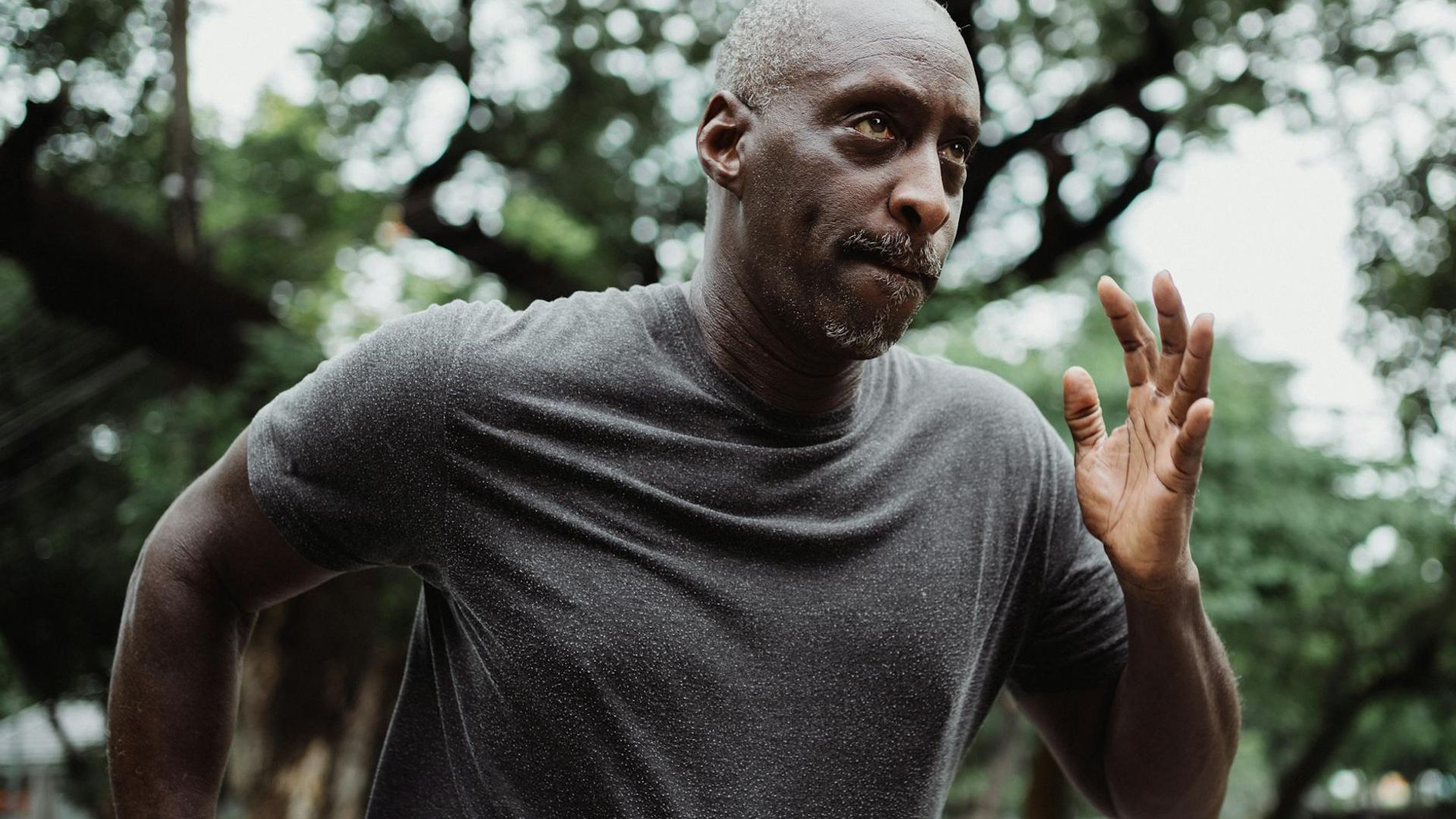 Person performing a calm, focused cardio movement in a minimalist space.